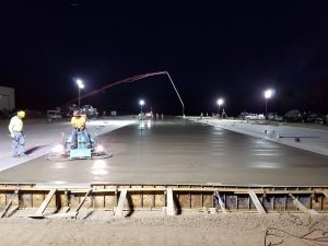 Pouring concrete and keeping it wet so it doesn't dry out